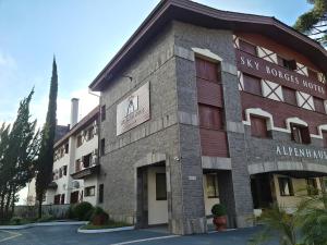 a building with a sign that reads sky boxes hotel at Alpenhaus Gramado Flat Temporada in Gramado