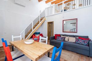 a living room with a table and a couch at House in the Historic Center- Portimão in Portimão