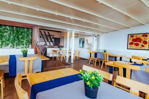un restaurante con mesas y sillas de madera y una habitación en The Milltown Hotel, en Estambul