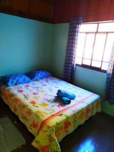 a bedroom with a bed with a phone on it at POUSADA DO BAR- BUDO in Visconde De Maua