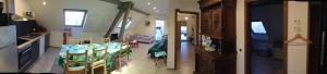 a kitchen and a living room with a table and chairs at Appartement charmant à Lohr + 60 m² + terrasse et jardin in Lohr