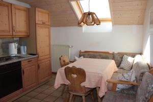 a kitchen with a table and a couch in a room at Brombergerhof Münsing in Münsing