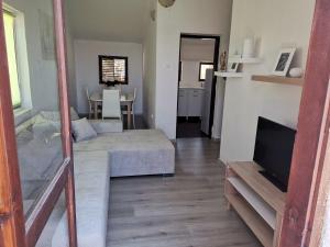 a living room with a couch and a table at Villa Rose Ann in Rogoznica