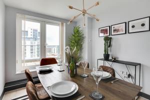 uma sala de jantar com uma mesa e cadeiras e uma janela em The Marina Penthouse em Ipswich