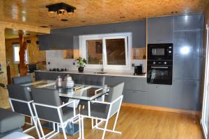 a kitchen with a table and chairs in a kitchen at Casa do Outeiro in Arcos de Valdevez