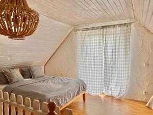 a bedroom with a bed and a chandelier at Apartmenthaus Lütt Meer in Ludorf +92 photos