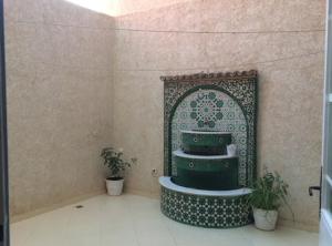 a bathroom with a sink in a wall with plants at Appart sur Fes in Fez