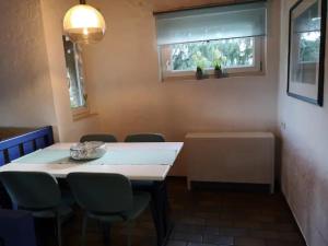 a room with a table and chairs and a window at Maja am See in Biersdorf am See +21 photos