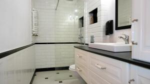 a white bathroom with a sink and a toilet at Vintageapartment in Sopot
