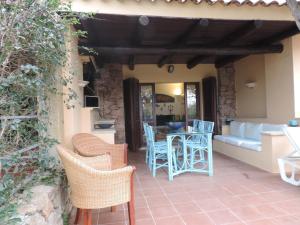 a patio with chairs and a table and a couch at Punta Lada in Porto Rotondo