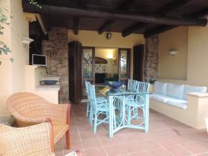 a patio with a table and chairs and a couch at Punta Lada in Porto Rotondo