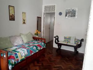 a bedroom with a bed and a chair in it at Apartamento Av Atlantica in Rio de Janeiro