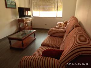 a living room with a couch and a coffee table at Piso in Cedeira