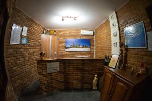 a room with a brick wall with a sink in it at Pousada Panorama in Praia do Frances