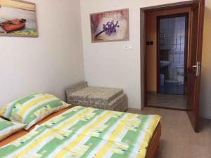 A bed or beds in a room at House and Apartment Balatonmariafürdo 19319