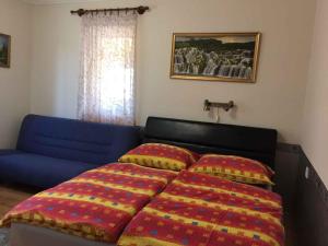 A bed or beds in a room at House and Apartment Balatonmariafürdo 19319