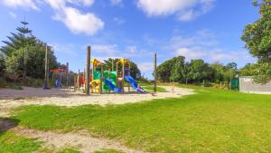 a playground in a park with a playground at Camp Waipu Cove in Waipu
