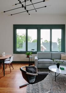 a living room with a couch and a chair at The Amelia in Hudson