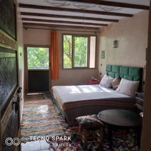 Rúm í herbergi á Riad Atlas Garden