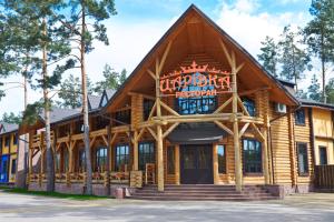 a log cabin building with a sign on it at Carivka Hotel in Tsarivka