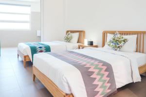 A bed or beds in a room at K Gallery Hotel