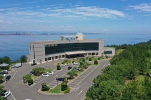 an aerial view of a building with a parking lot at Hotel Marine in Pohang