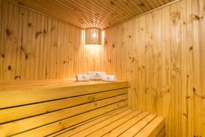 a sauna with wooden walls and a wooden floor at Urban Green Hotel & Suites in San José +58 photos