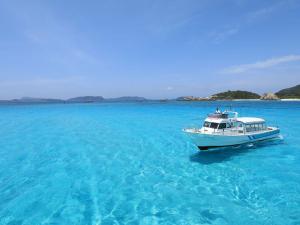 a boat in the middle of the ocean at Pension Sea Friend in Tokashiki