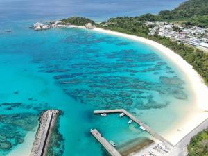 an aerial view of a beach with a boat in the water at Pension Sea Friend in Tokashiki