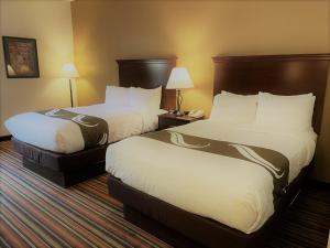 A bed or beds in a room at Quality Inn Danville - University Area