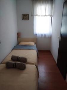 two beds in a small room with a window at Apartment Croatia in Poreč