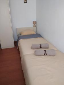 a bedroom with two beds with towels on them at Apartment Croatia in Poreč