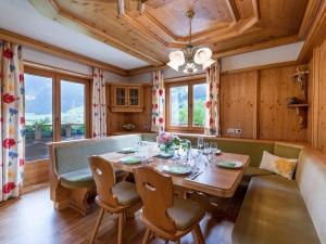 a dining room with a table and a couch at Appartement Andrea Hauser - Riedltischler in Zell am Ziller
