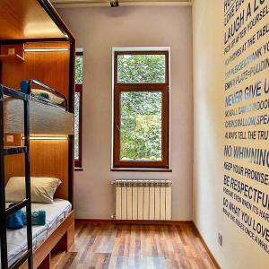 a room with a bunk bed and a window at Central Hostel in Sheki
