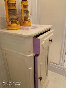a white cabinet with two drilling machines on top of it at Verde Mare in Alassio +25 photos