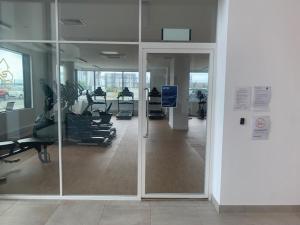 an empty gym with chairs and a glass door at Gillingham One in Gillingham