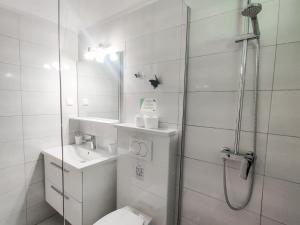 a bathroom with a shower and a toilet and a sink at Marios in Brela