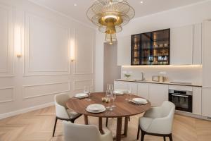 a dining room with a wooden table and chairs at Plaza Apartments in Opatija
