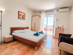 a bedroom with a bed and a living room at Marios in Brela
