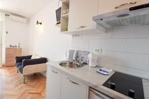 a kitchen with a sink and a counter top at Marios in Brela