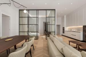 a dining room with a table and chairs and a kitchen at Plaza Apartments in Opatija