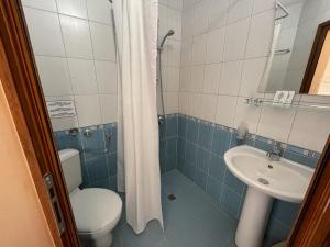 a bathroom with a toilet and a sink at Hotel Vega in Kranevo +18 photos