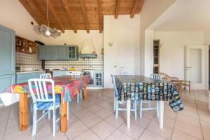 a kitchen with a table and chairs in a room at Casa Core in San Lorenzo in Banale