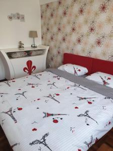 a bedroom with a bed with a bedspread with weapons on it at Lux Apartman Ristić 2 in Soko Banja