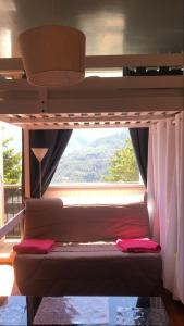 a bedroom with a bunk bed with a large window at Chez So Orcieres in Orcières