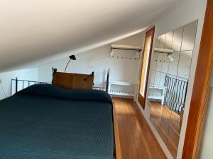 a bedroom with a large bed and a staircase at Miniloft panoramico in Rio nellʼElba