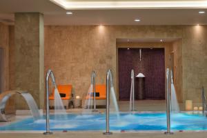 a swimming pool with water fountains in a hotel room at Melia Dunas Beach Resort & Spa in Santa Maria