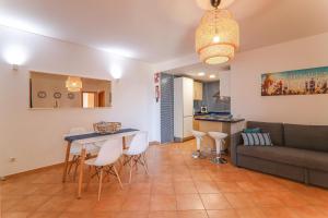 a living room with a couch and a table and chairs at Olival Beach in Armação de Pêra