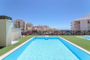 a swimming pool on the roof of a building at Olival Beach in Armação de Pêra