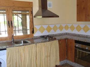 a kitchen with a sink and a counter top at El Molino de Iramala in Reolid